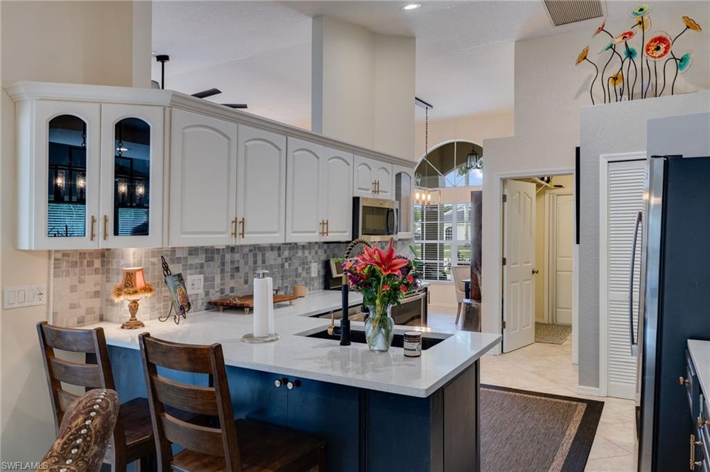 Enjoy cooking in this inviting kitchen with stools for friends to converse while cooking.