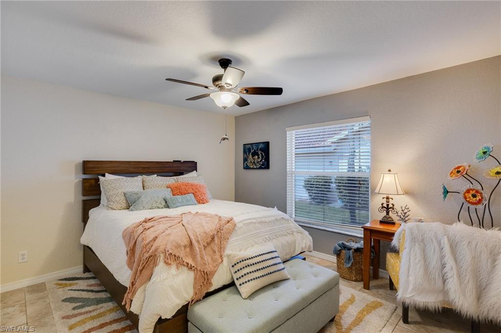 One of the two guest rooms that offers plenty of space for desk and bed.  Shared bathroom in between the two bedrooms. One of many ceiling fans throughout the home.