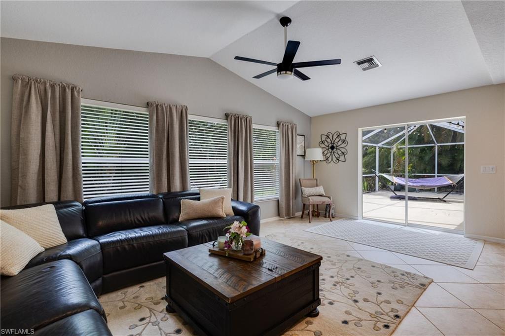 This large open air family room comes complete with the sofa and cocktail table and wonderful views to the back space.  Great for entertaining.
