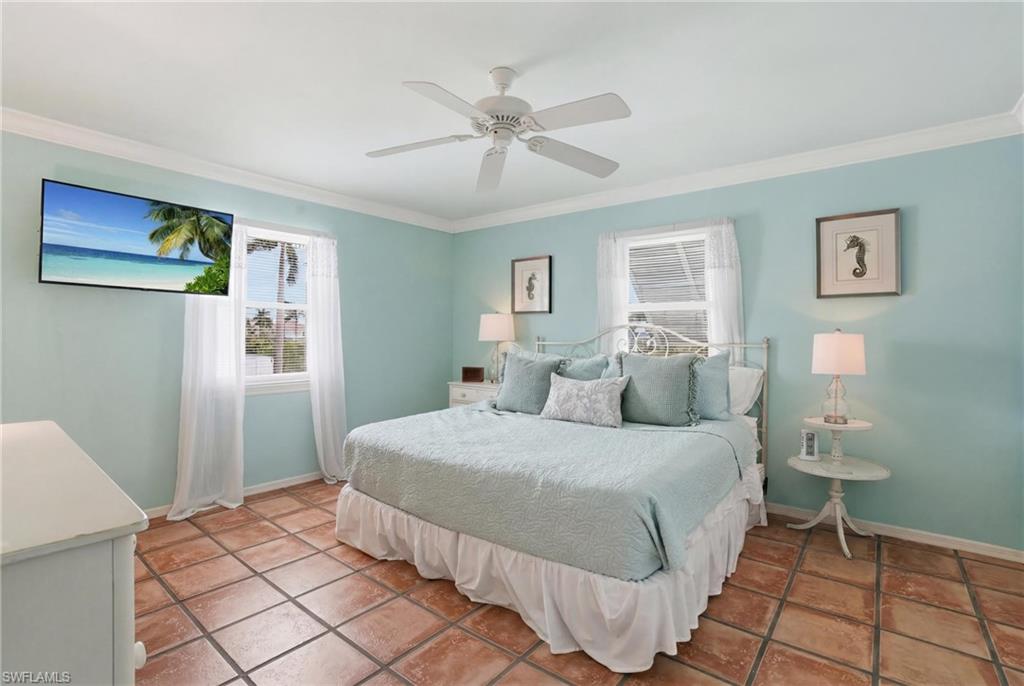 Room featuring terra cotta tile flooring and light blue walls - Virtually Edited Image