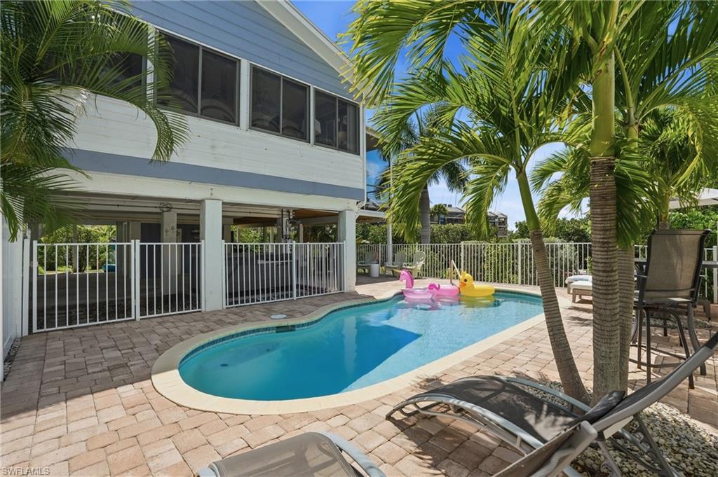 Freeform swimming pool surrounded by paver decking - Virtually Edited Image