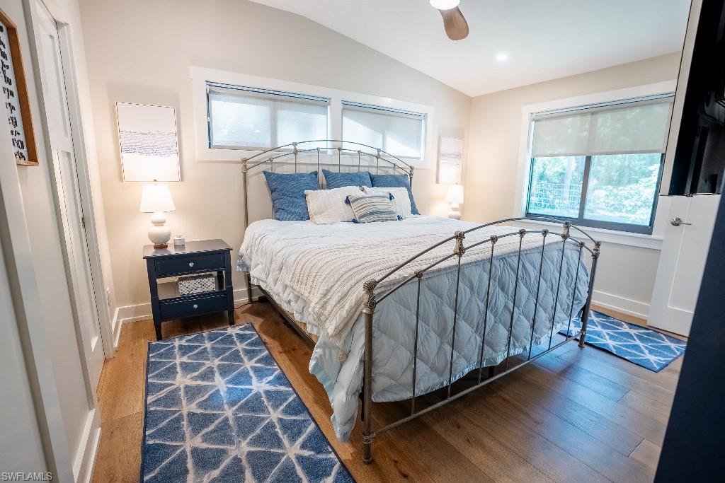Warm wood-finish flooring complements neutral wall tones in this bedroom