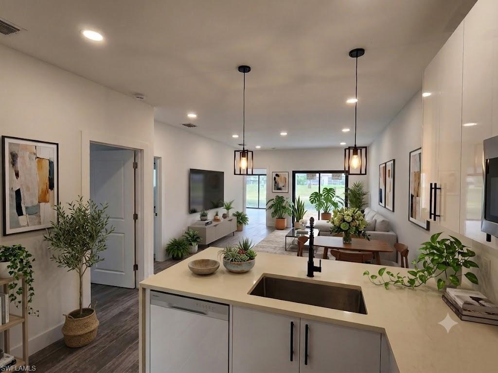 Open-concept living space with recessed lighting and two pendant fixtures