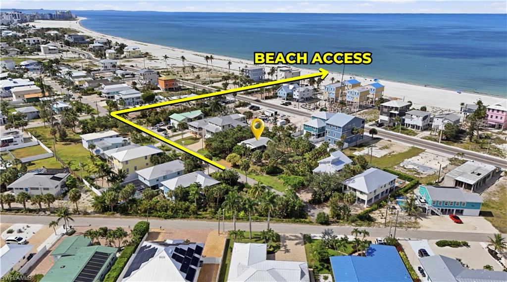 Aerial perspective showcasing proximity to the Gulf of Mexico, surrounded by other residential properties - Virtually Edited Image