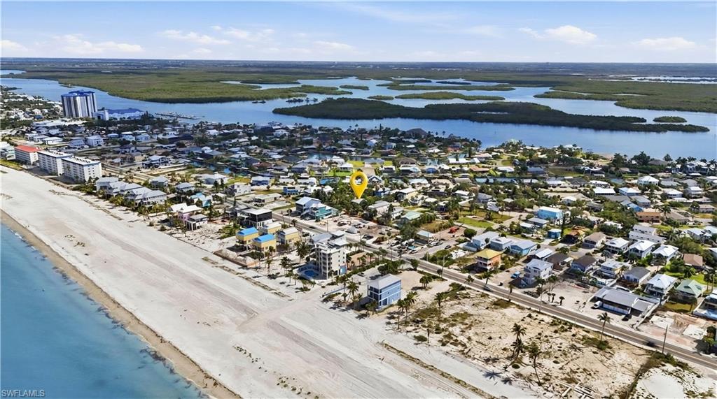 Aerial perspective showcasing a coastal community with extensive beachfront and adjacent waterways - Virtually Edited Image