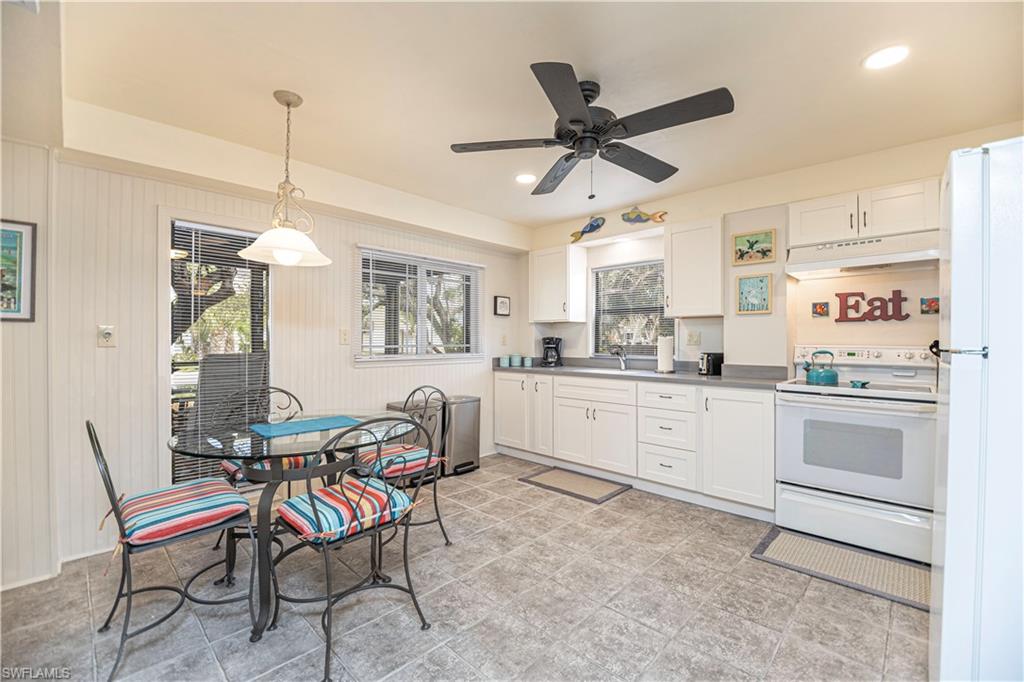Kitchen featuring white cabinetry, gray countertops, and tile flooring - Virtually Edited Image