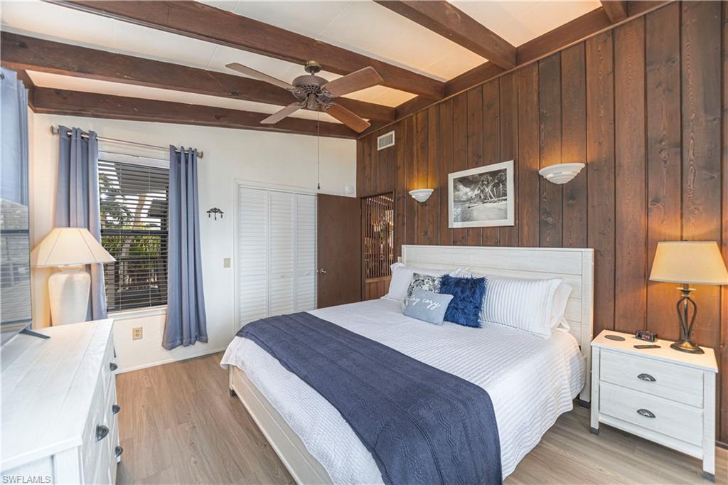 Wood-paneled accent wall with integrated sconce lighting - Virtually Edited Image