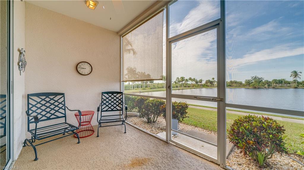 Sunroom featuring a water view