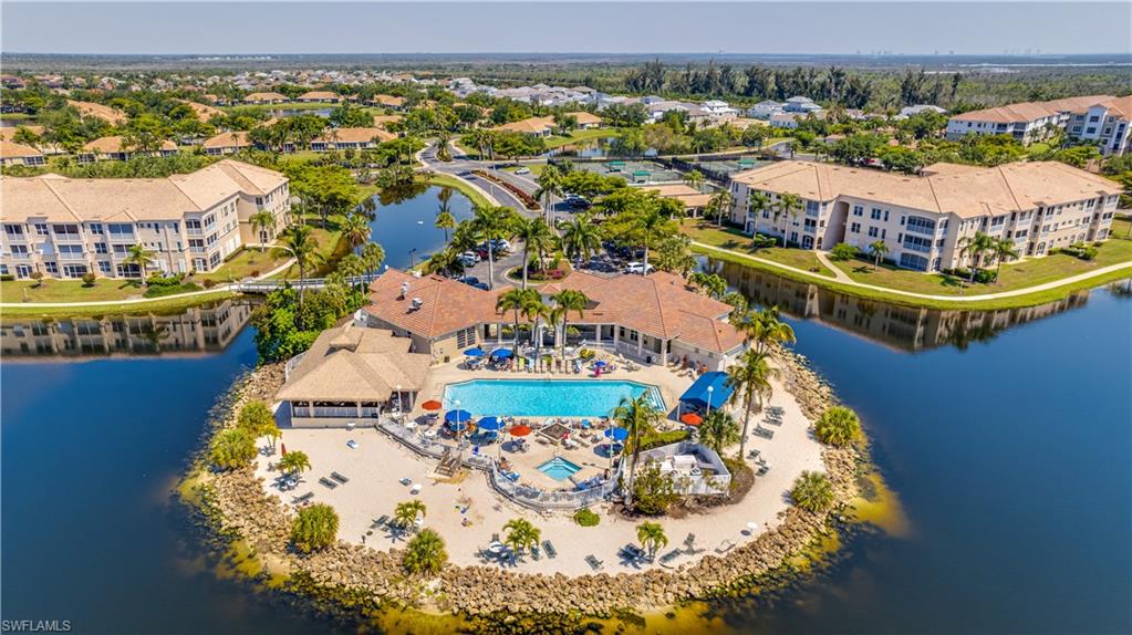 Bird's eye view of a pool area and a nearby body of water