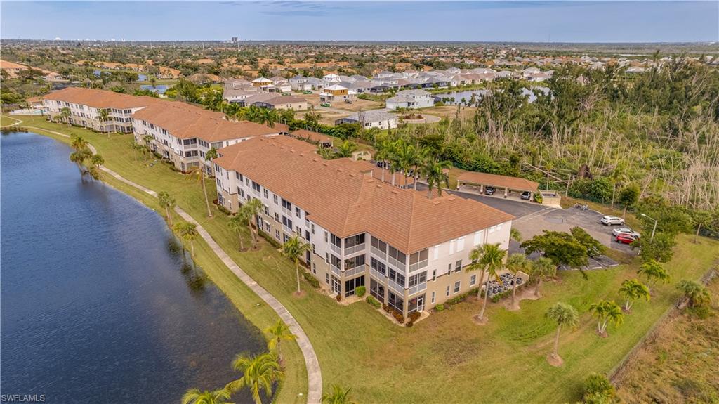 Aerial view featuring a residential view and a water view