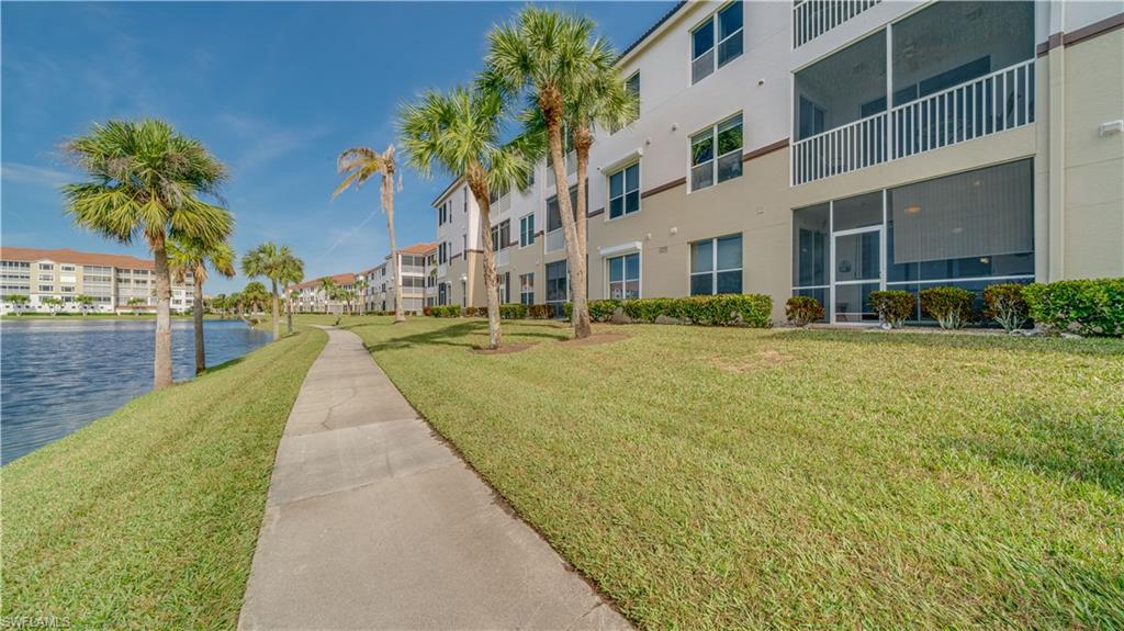 View of home's community with a lawn, a water view, and a residential view