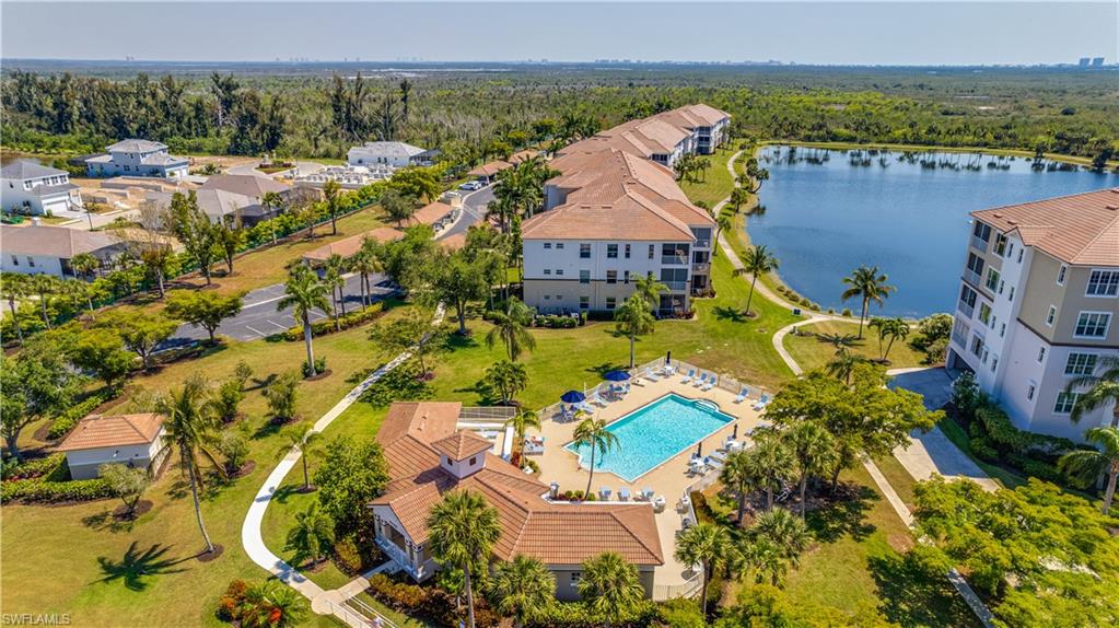 Aerial view of a pool and a nearby body of water