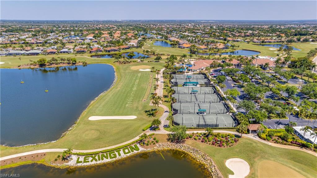 Aerial perspective of suburban area with a golf club and a nearby body of water