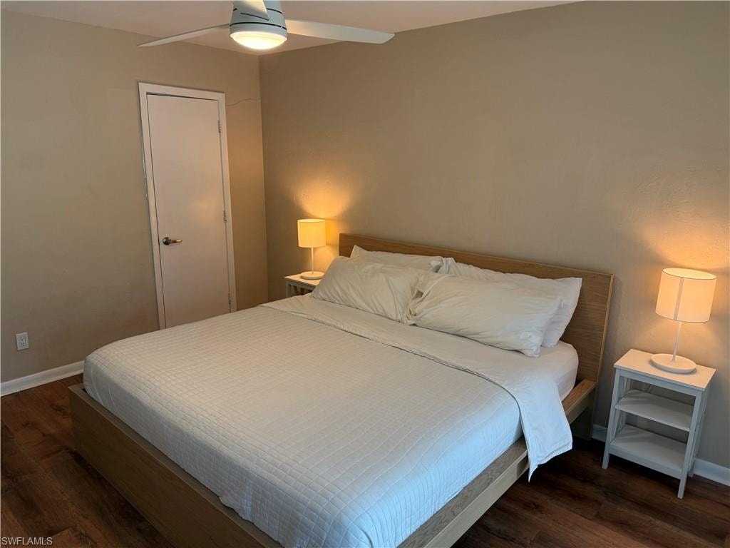 Bedroom featuring dark wood-type flooring and ceiling fan