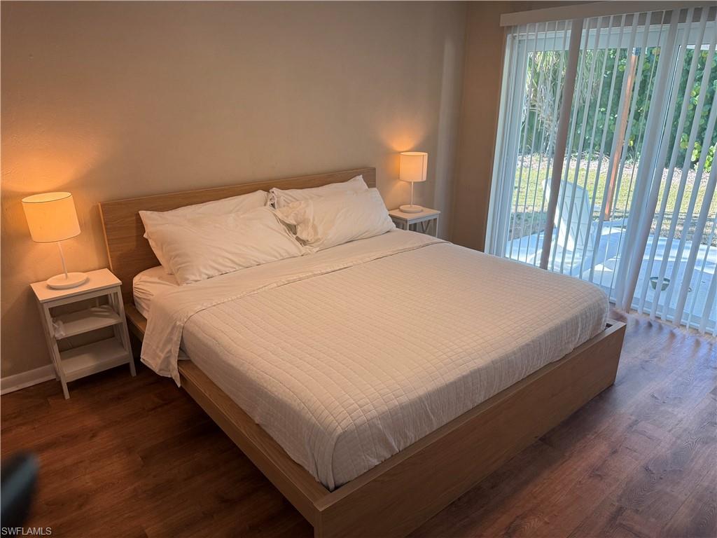 Bedroom featuring dark wood finished floors and access to outside