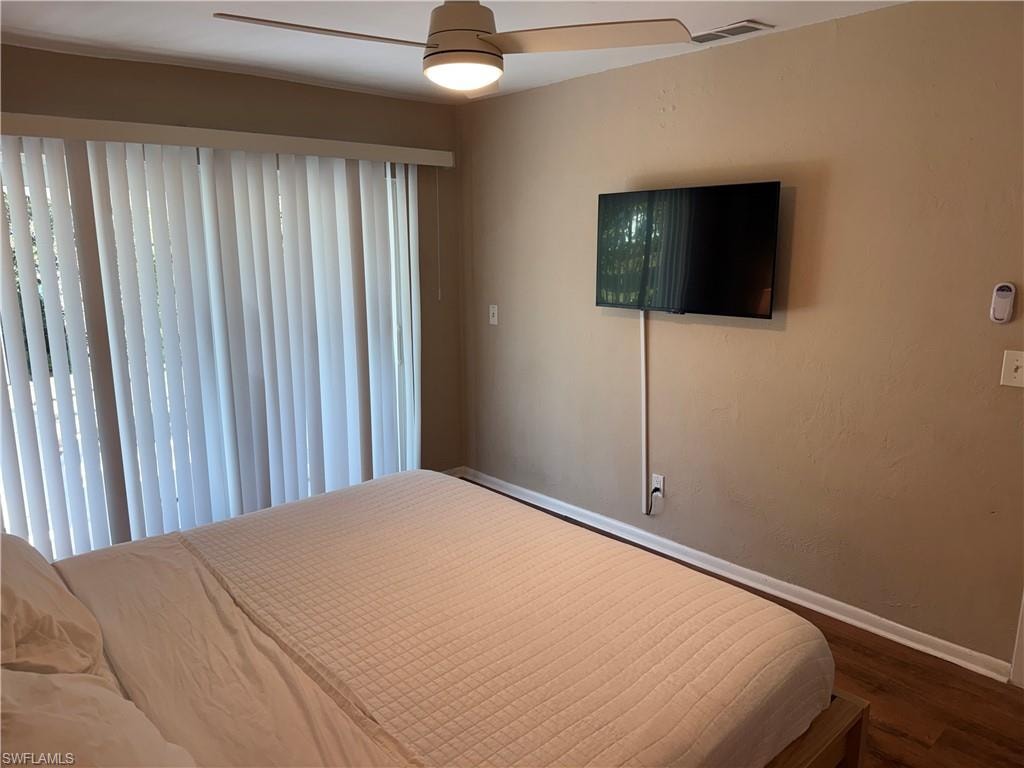 Bedroom featuring a ceiling fan and dark wood-style floors