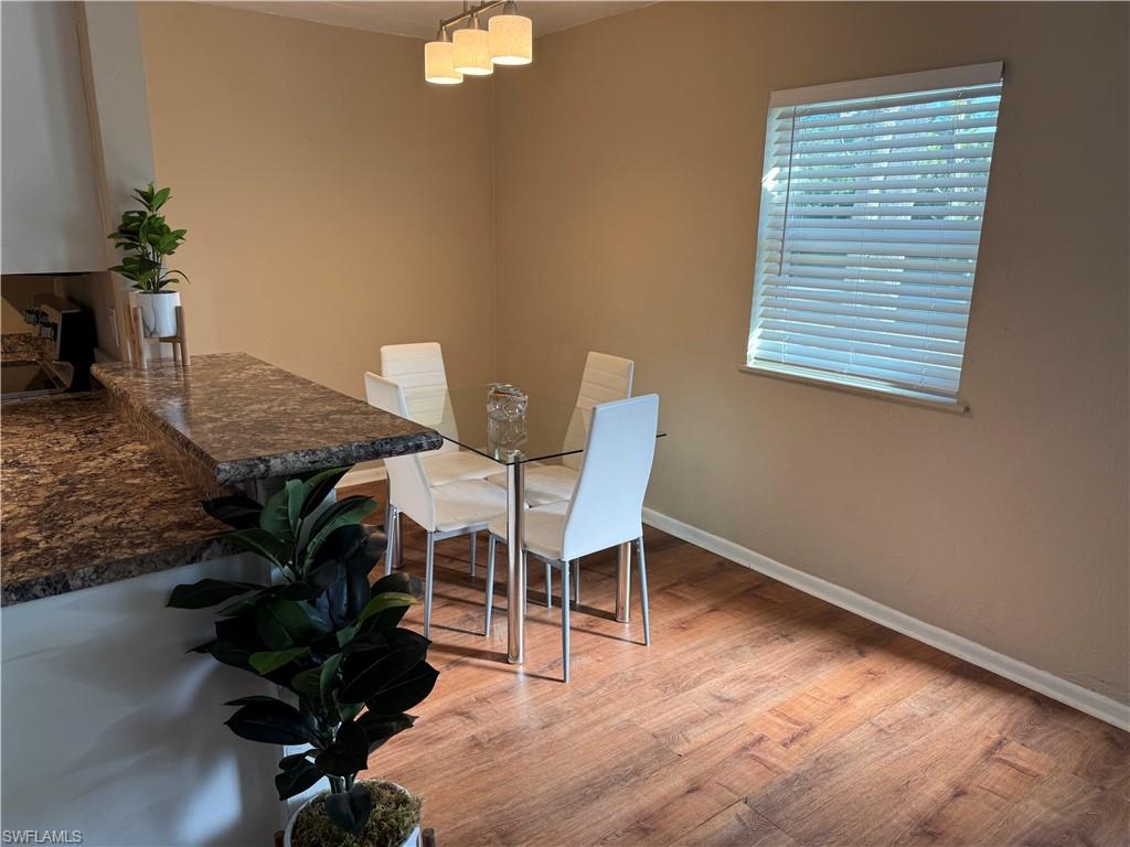 Dining area with light wood-style flooring and baseboards