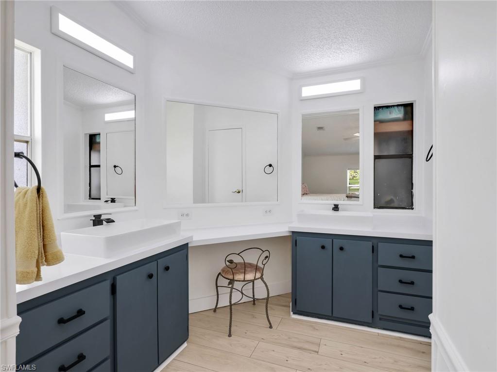 Bathroom featuring wood-finish flooring, white walls, and a white ceiling