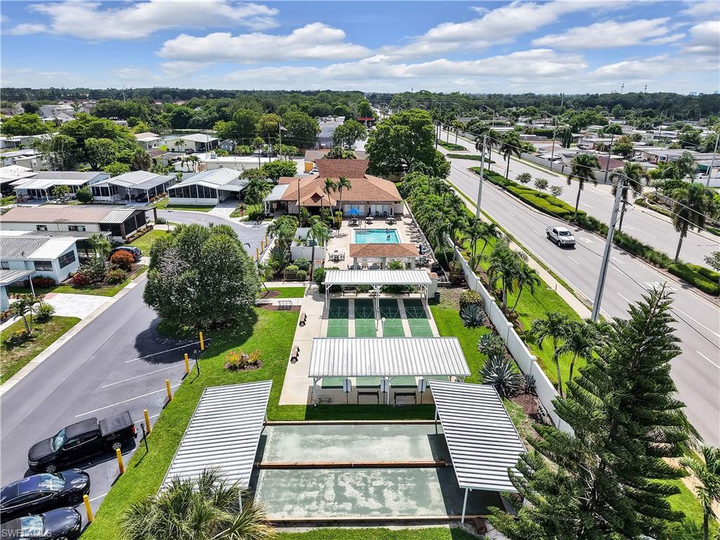 Community amenities featuring a swimming pool, multiple shuffleboard courts, and bocce ball courts with covered spectator areas