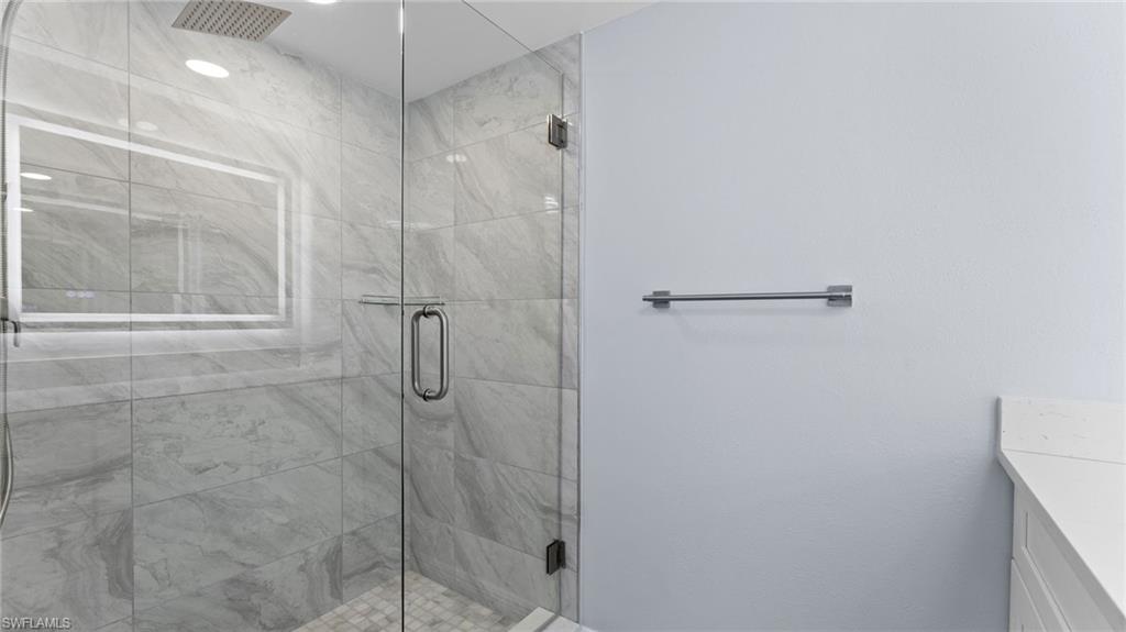 Bathroom with vanity and a shower stall