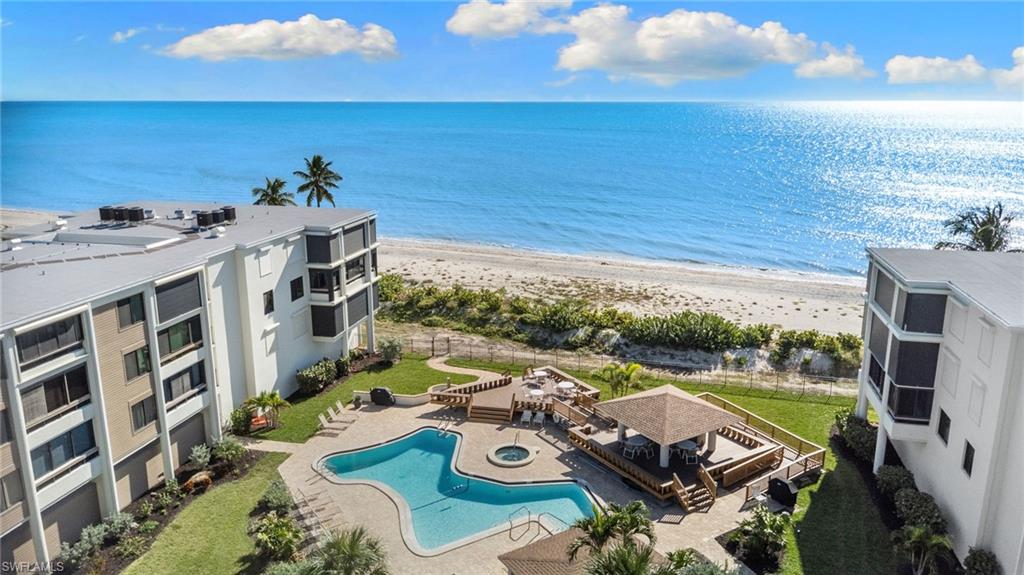 Water view featuring local beach and a fenced backyard