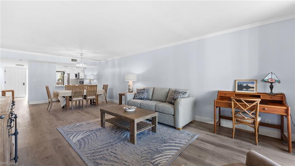 Living room with wood finished floors and a chandelier