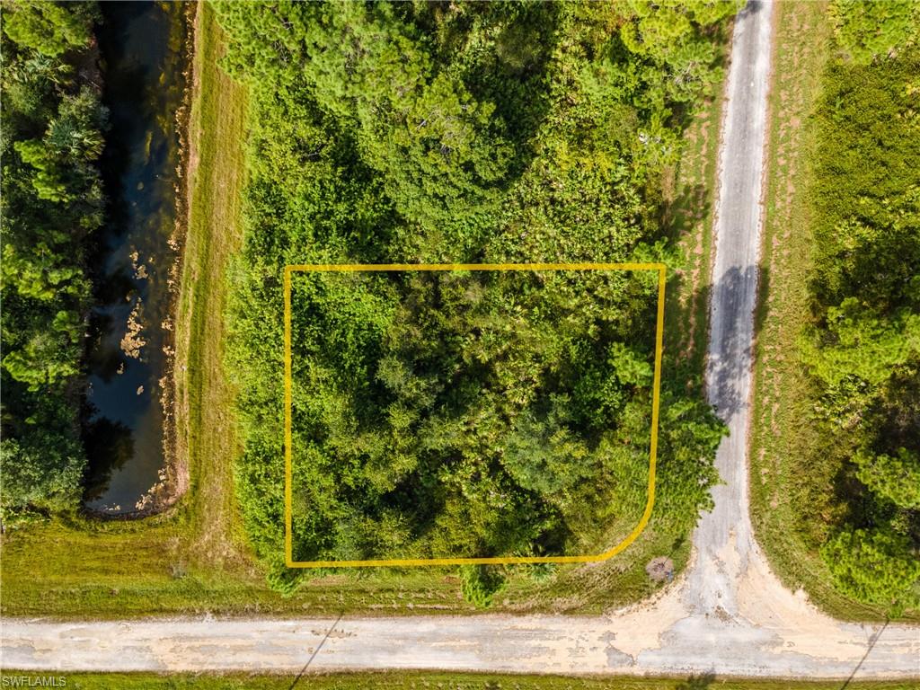 Aerial overview of property's location featuring property parcel outlined and a nearby body of water