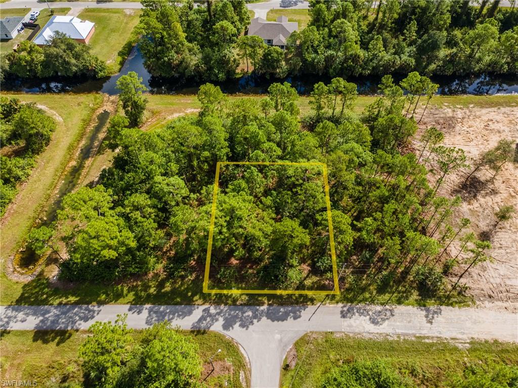 Aerial view of property's location featuring a nearby body of water and property parcel outlined