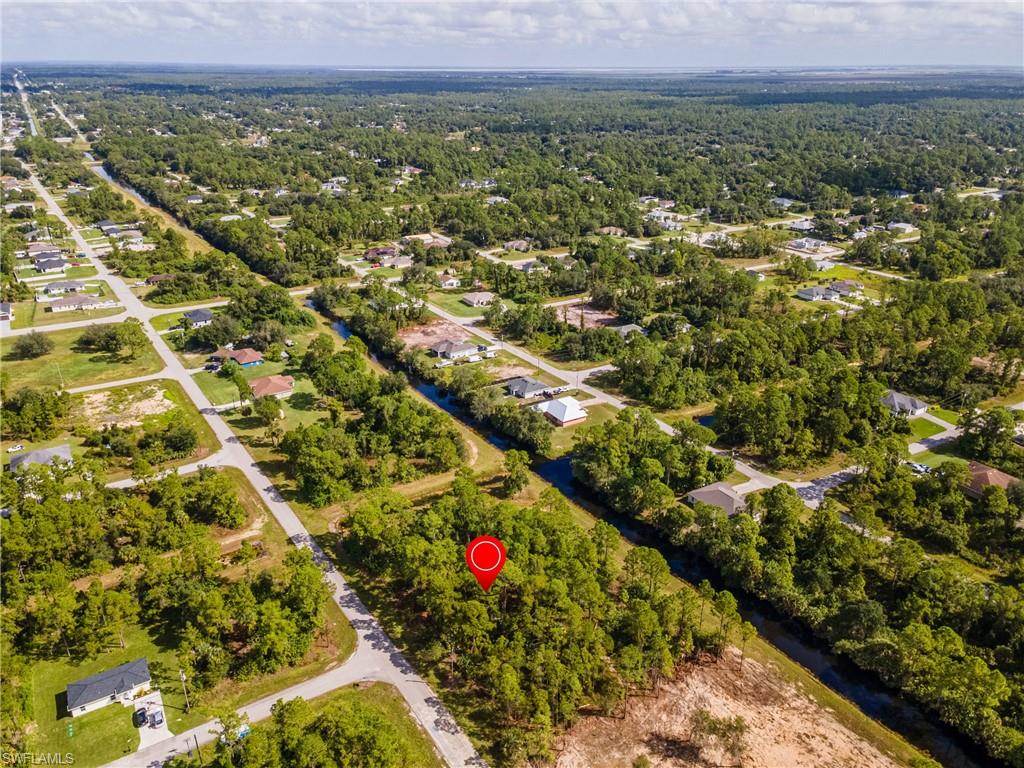 View of property location featuring nearby suburban area and a nearby body of water