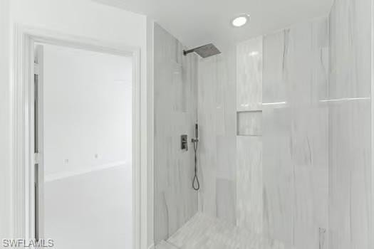 Bathroom featuring a marble finish shower