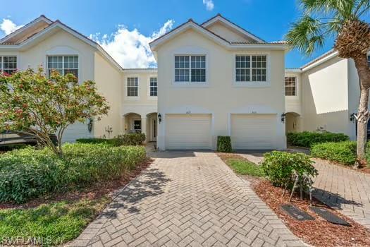 Mediterranean / spanish-style house featuring driveway, an attached garage, and stucco siding