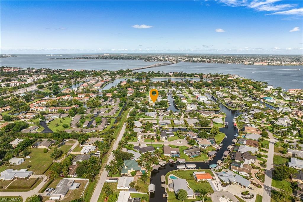 Aerial perspective showcasing a residential area with canal access, multiple homes, and surrounding waterways