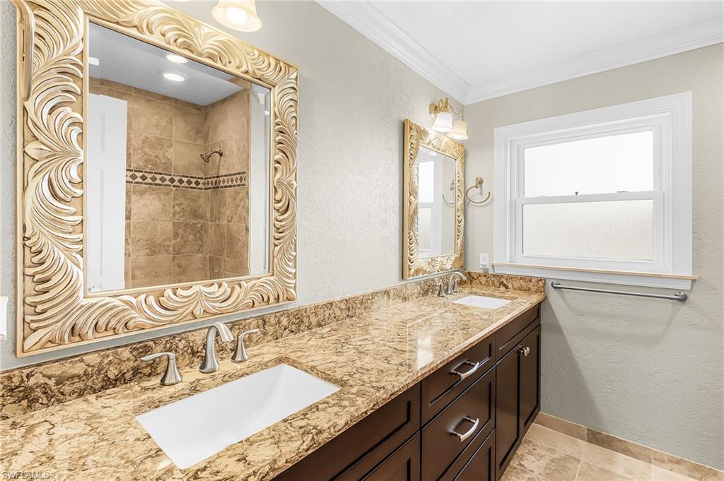Dual vanity with stone-finish countertops and integrated rectangular sinks