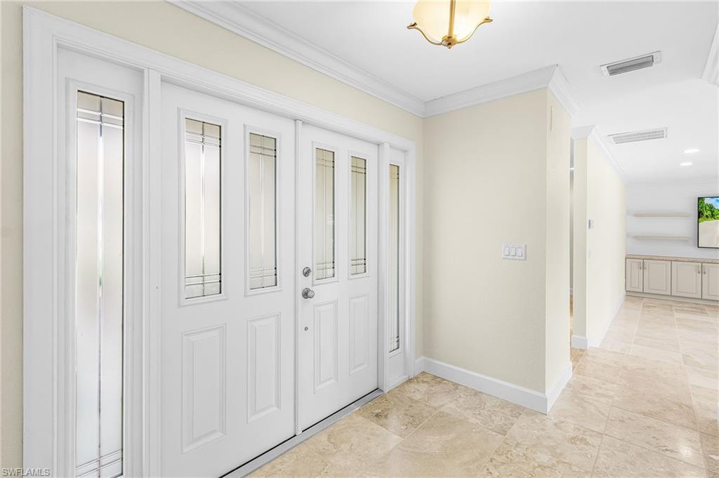 Double entry doors with decorative glass inserts and side lites