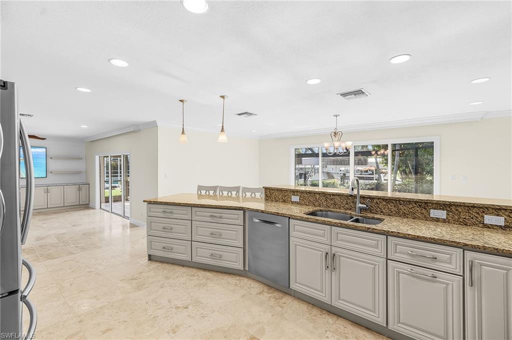 Kitchen featuring light-toned cabinetry, granite countertops, and stainless steel appliances