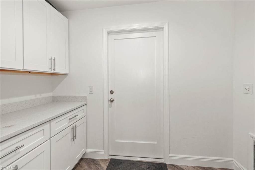 The laundry room has matching kitchen countertops with top and lower storage which doubles as a pantry area.