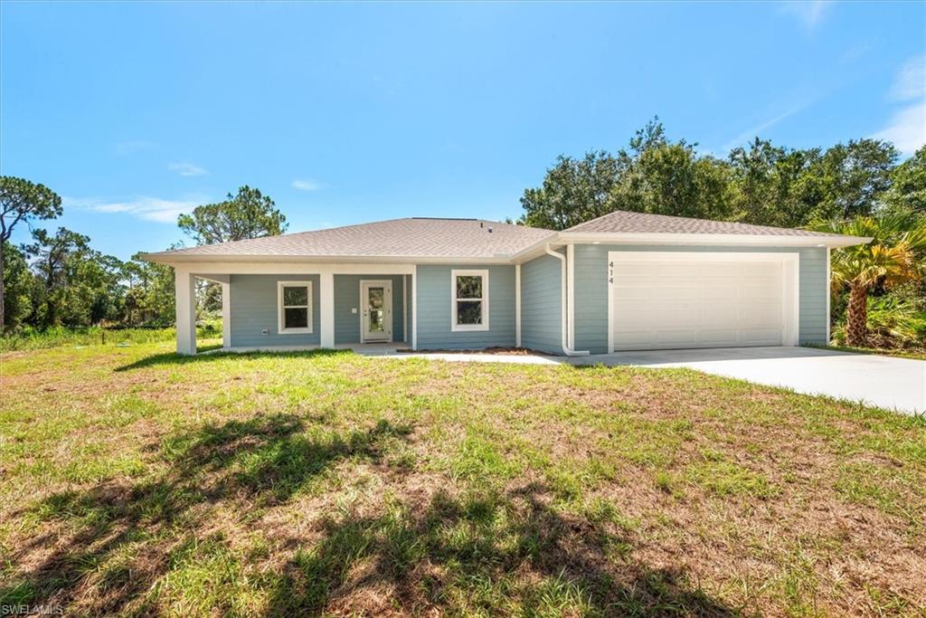 The front yard view with a large front porch and recessed can lighting. The front has a plank style concrete mortar finish that looks great and is much more durable.