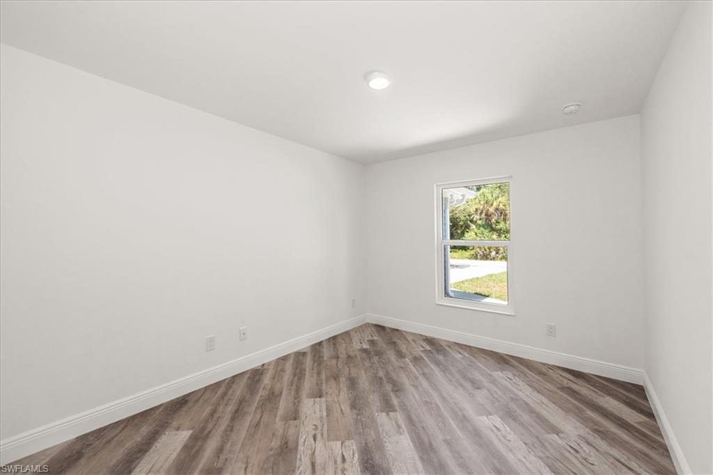 Front center guest bedroom with a front yard view.