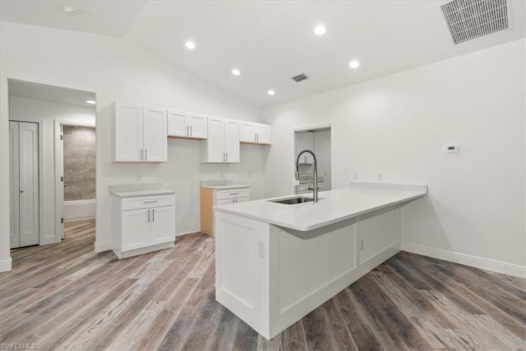The kitchen features quartz countertops with bar seating with a large counter space. Perfect for entertaining while the chef prepares the meal.