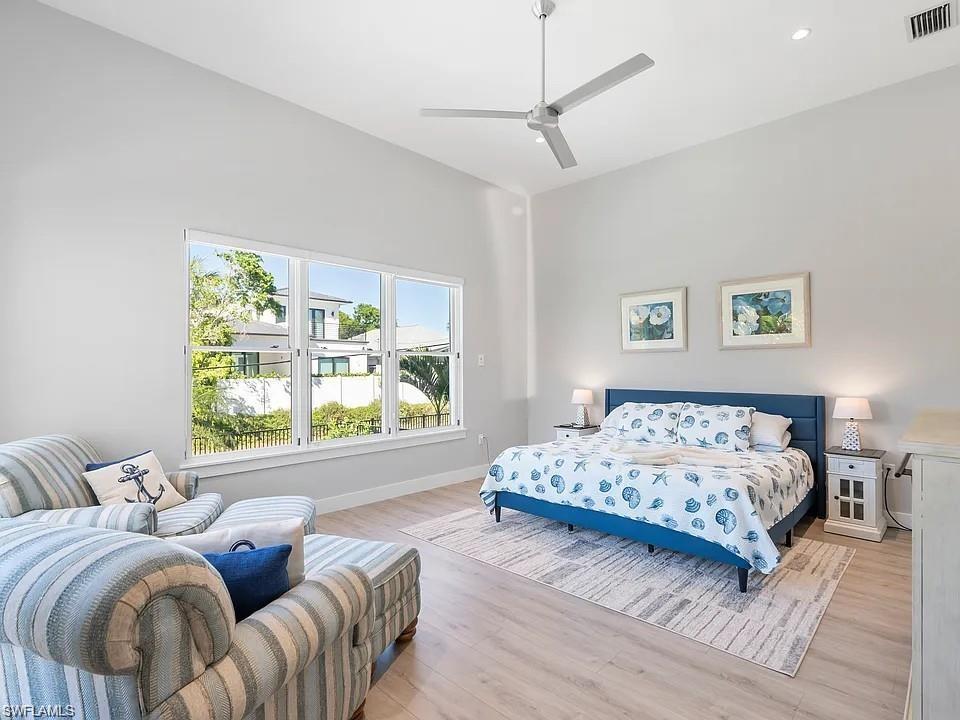 Vaulted ceiling with a contemporary ceiling fan and recessed lighting