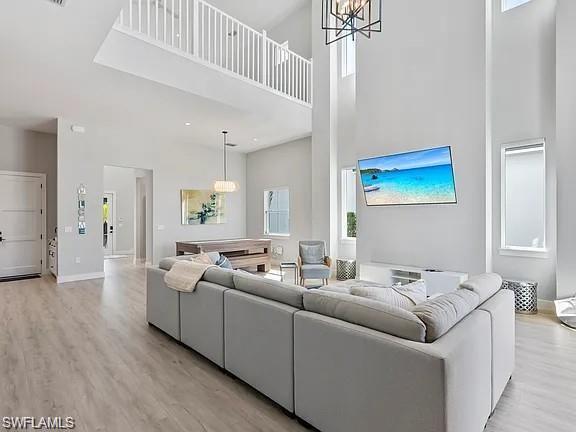 Expansive living area featuring soaring ceilings and light wood-finish flooring