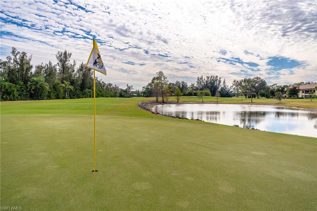 Manicured green with a flagstick, featuring a substantial water hazard