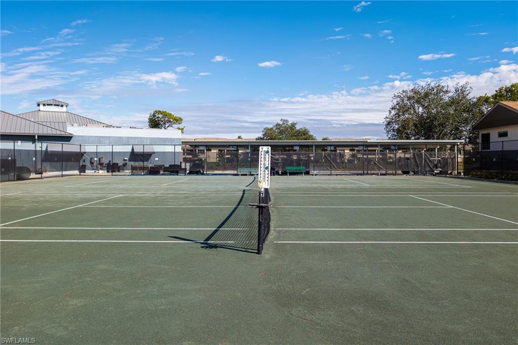 Two tennis courts featuring a green surface and white court lines