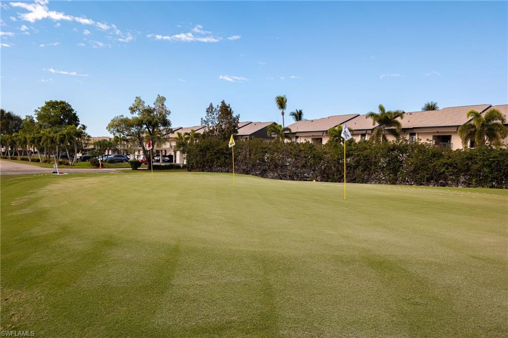 Expansive green space featuring golf flags and surrounding mature landscaping