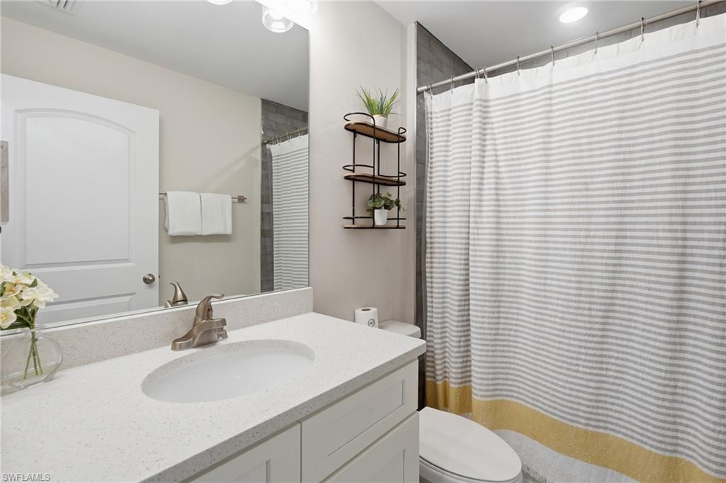 Bathroom featuring a white vanity with a light-colored countertop