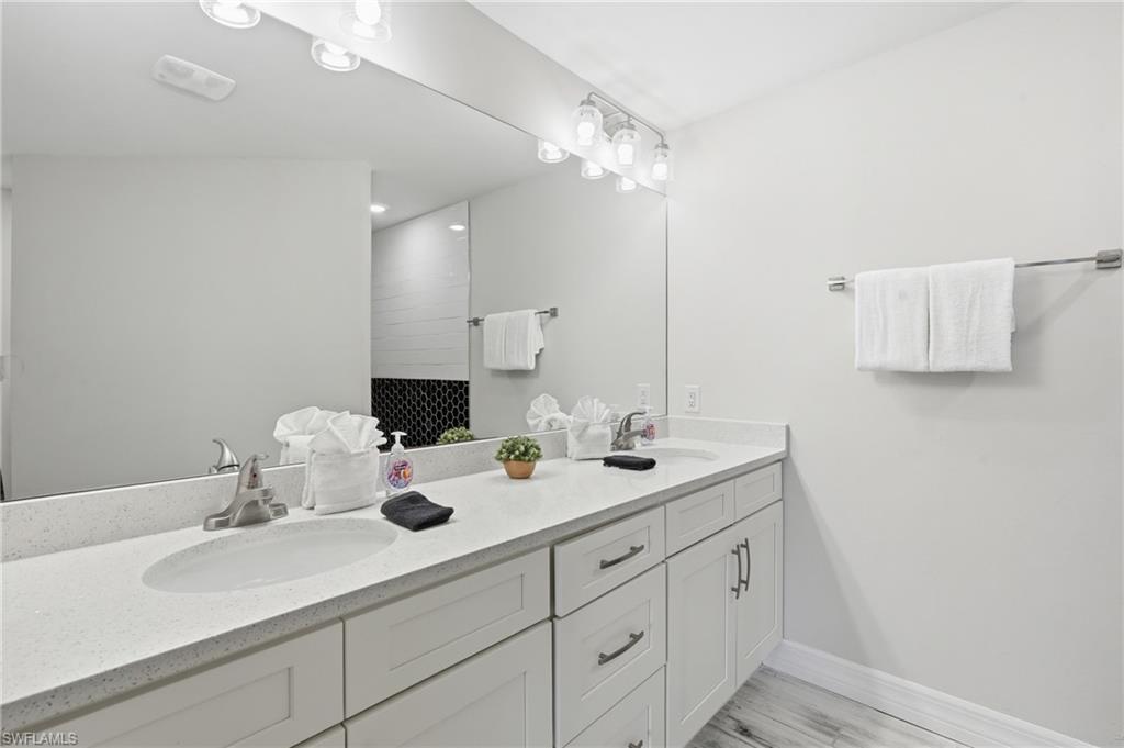 Dual vanity with an expansive countertop and white cabinetry