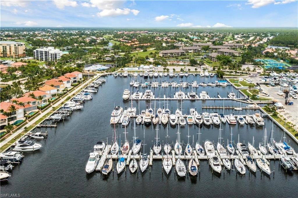 Marina with multiple boat slips, surrounded by waterfront residences and green spaces