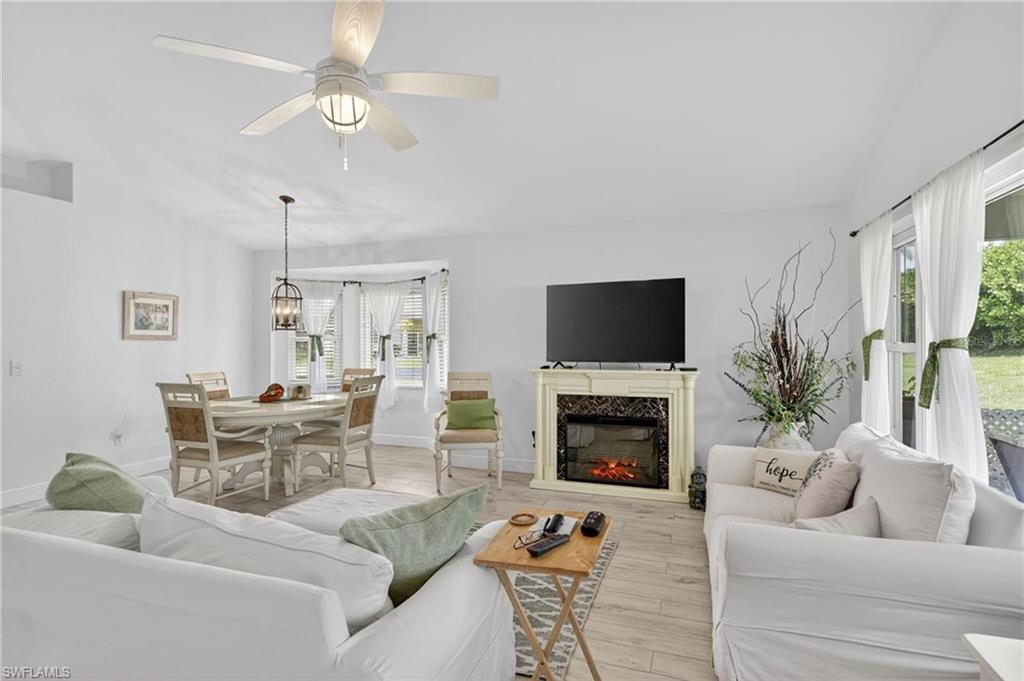 Open-concept living area with light-toned wood-finish flooring