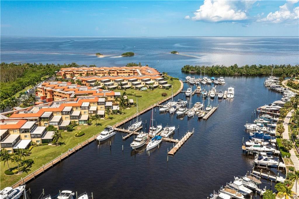 Waterfront community featuring a private marina with multiple boat slips, direct water access, and a collection of multi-story residences