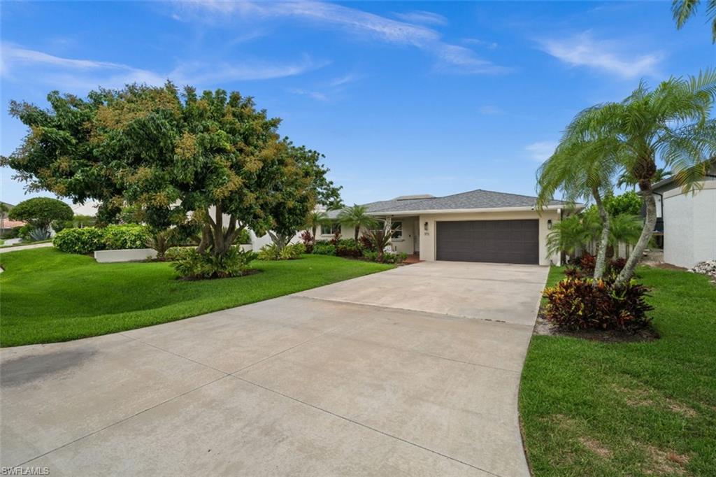 long driveway and beautiful landscaping